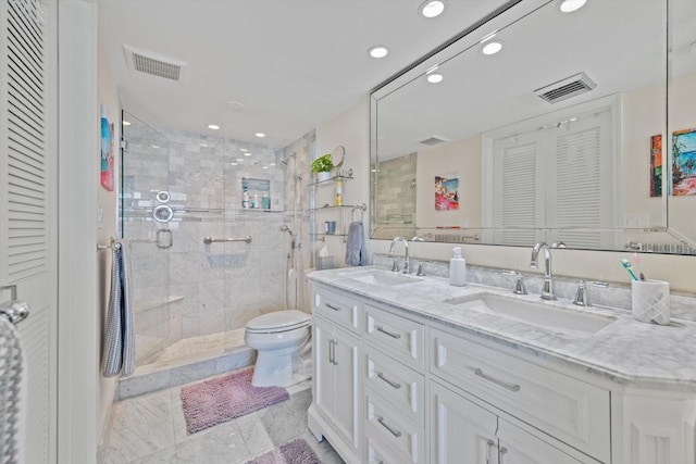 bathroom with vanity, toilet, and a shower with door