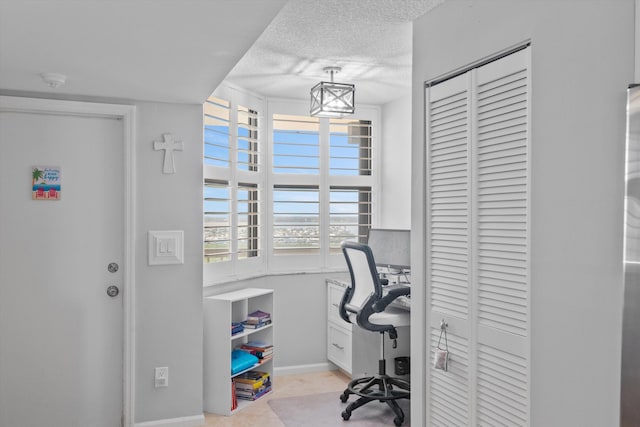 tiled home office featuring a textured ceiling