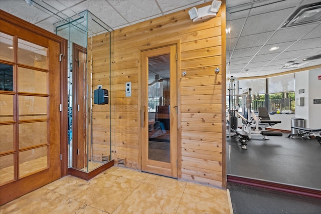 interior space featuring tile patterned floors and wooden walls