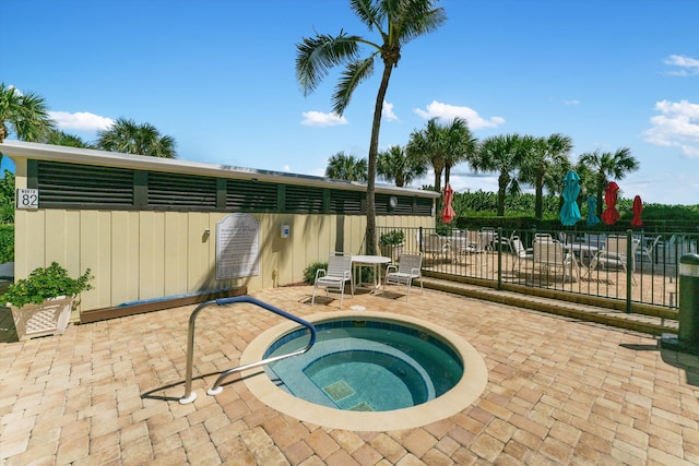 view of pool featuring a patio and a hot tub