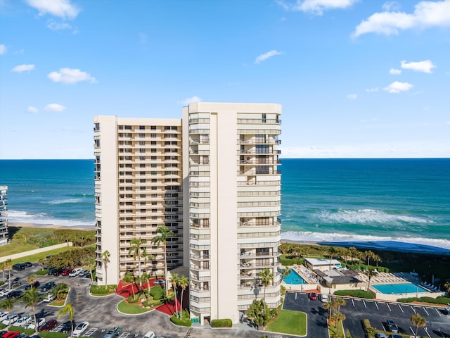 view of property with a view of the beach and a water view