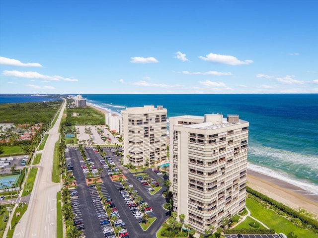 aerial view with a water view and a beach view