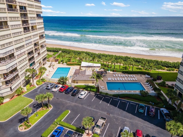 bird's eye view featuring a view of the beach and a water view