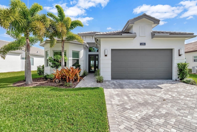 view of front of property with a front yard and a garage