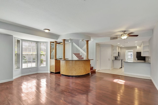 welcome area with ornate columns and ceiling fan