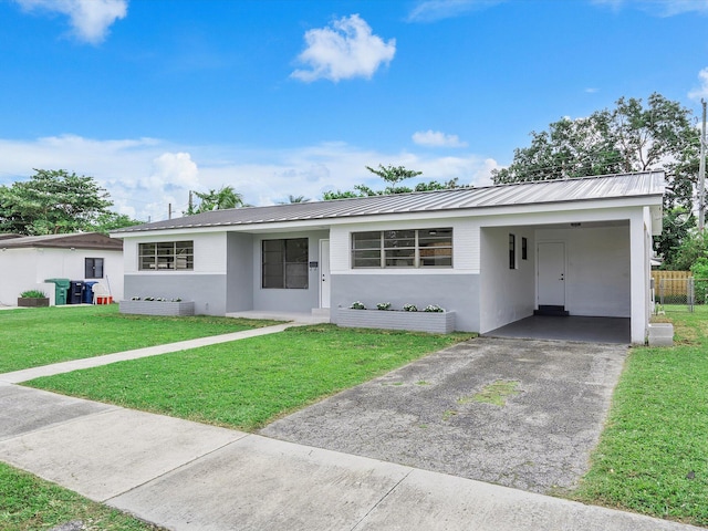 ranch-style house featuring a front yard and a carport