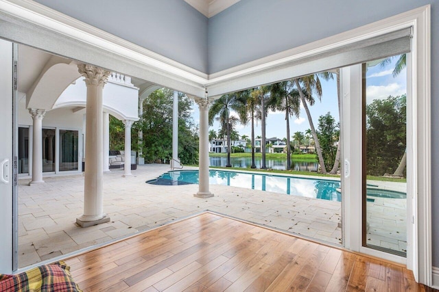 view of swimming pool featuring a patio and a water view