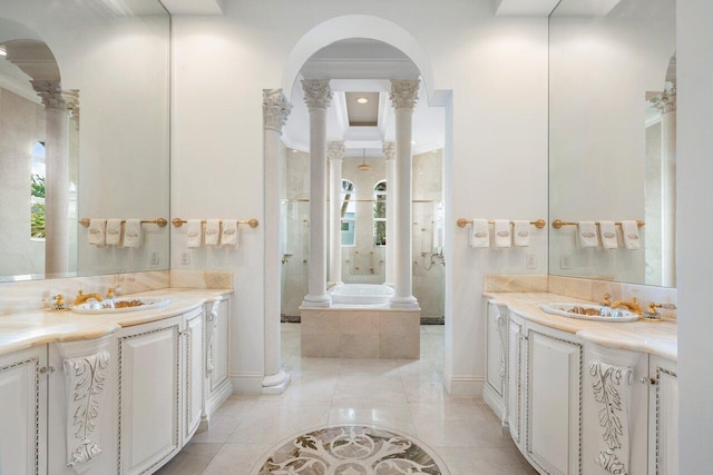 bathroom with a bathtub, vanity, tile patterned floors, ornamental molding, and decorative columns