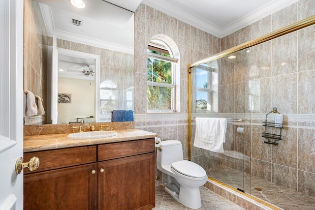 bathroom featuring ceiling fan, ornamental molding, tile walls, and vanity