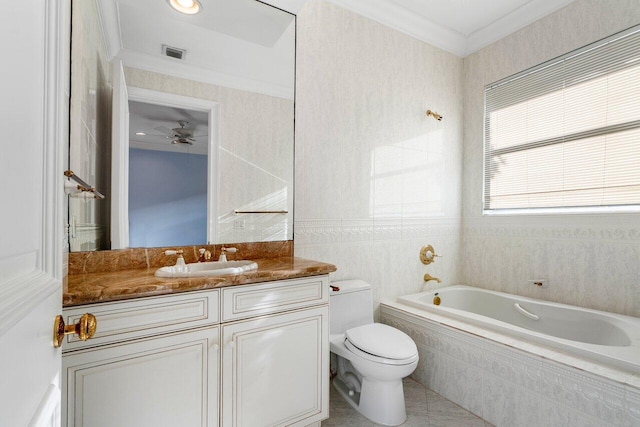 bathroom featuring tile patterned floors, tiled tub, toilet, vanity, and ornamental molding