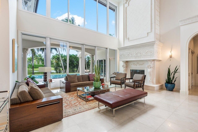 tiled living room with plenty of natural light and a high ceiling