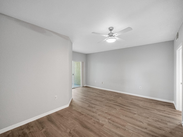 unfurnished room featuring hardwood / wood-style floors and ceiling fan