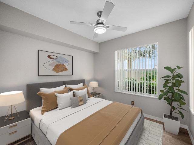 bedroom with ceiling fan and wood-type flooring