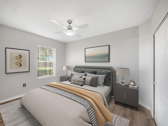 bedroom with hardwood / wood-style flooring and ceiling fan