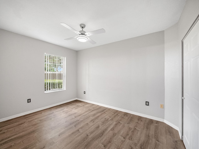 unfurnished room with ceiling fan and hardwood / wood-style floors