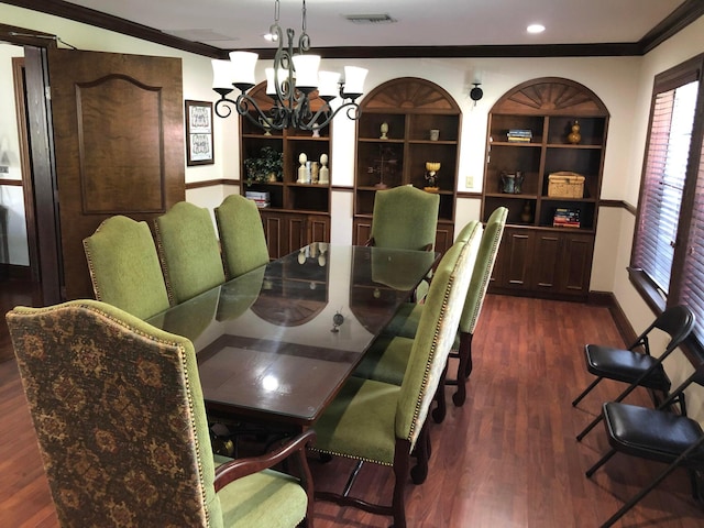 dining space with a chandelier, ornamental molding, and dark wood-type flooring