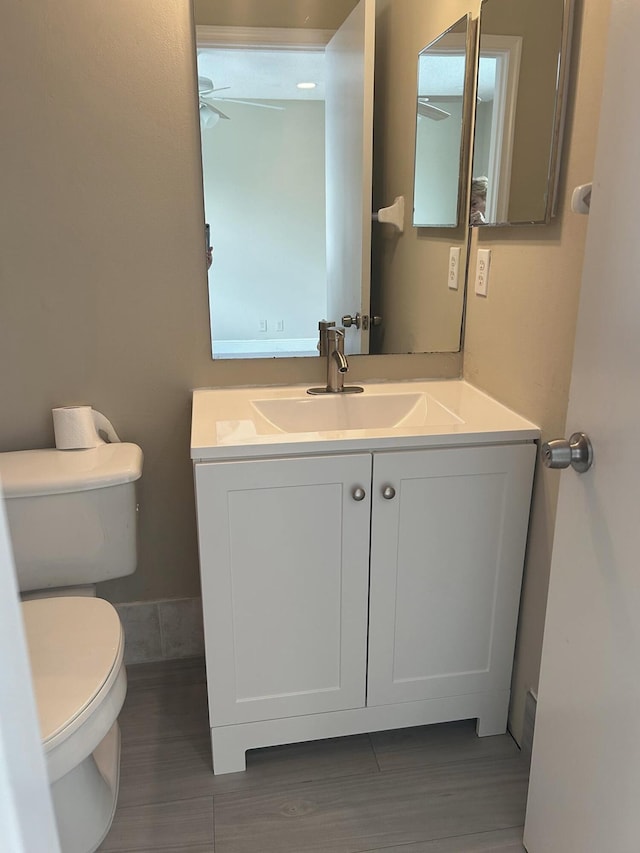 bathroom with toilet and vanity