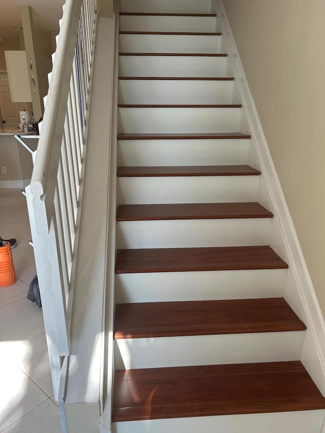 stairs featuring tile patterned floors