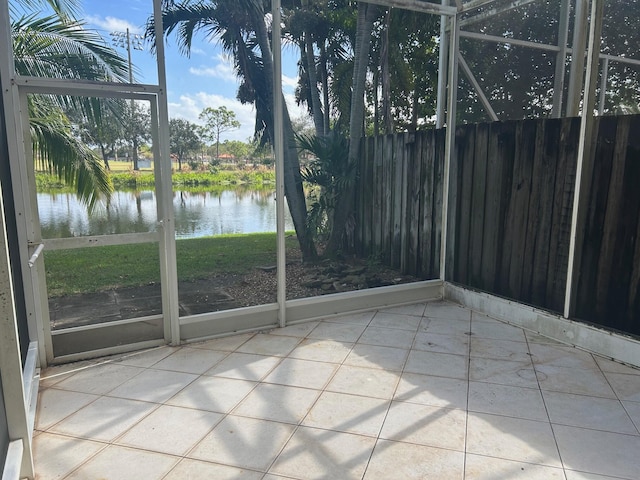 unfurnished sunroom with a water view