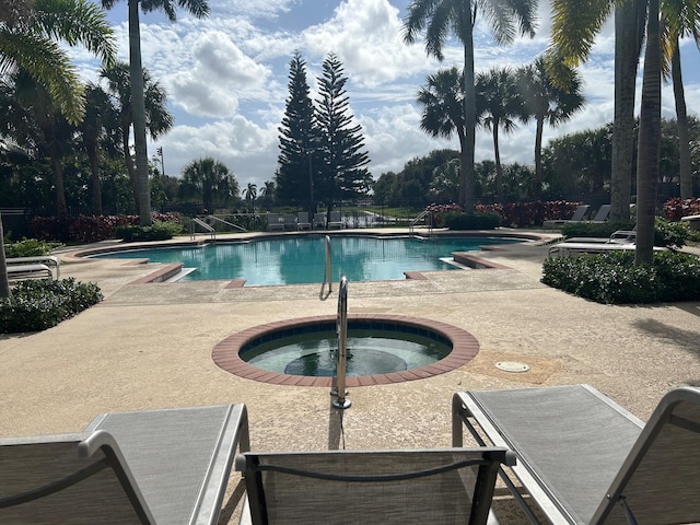 pool featuring a patio area and a hot tub