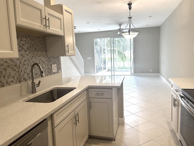 kitchen with light tile patterned floors, a peninsula, stainless steel appliances, a sink, and backsplash