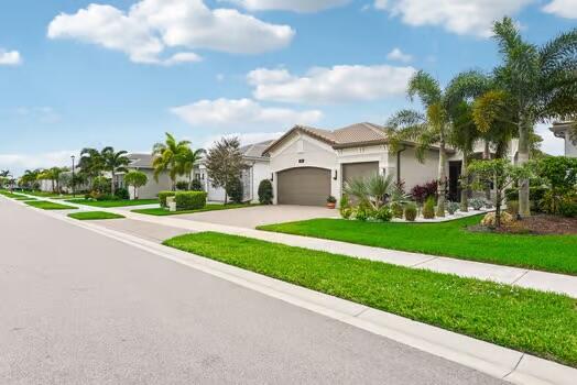 mediterranean / spanish house with a front lawn and a garage