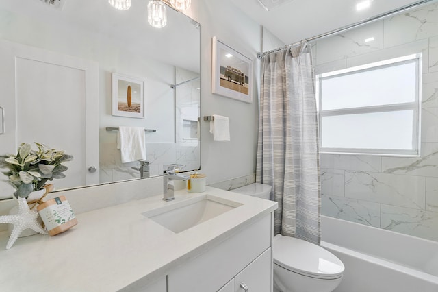 full bathroom with vanity, shower / bath combo, and toilet