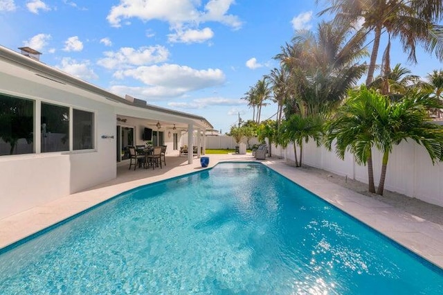 view of pool featuring ceiling fan and a patio