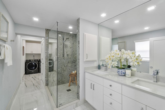 bathroom featuring independent washer and dryer, vanity, and a shower with shower door