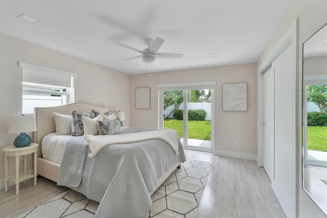 bedroom with ceiling fan, light hardwood / wood-style floors, access to outside, and a closet