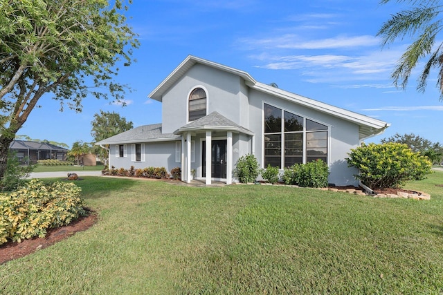 view of front of home with stucco siding and a front yard