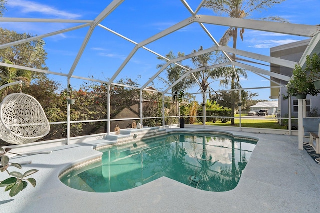 outdoor pool featuring a lanai and a patio area