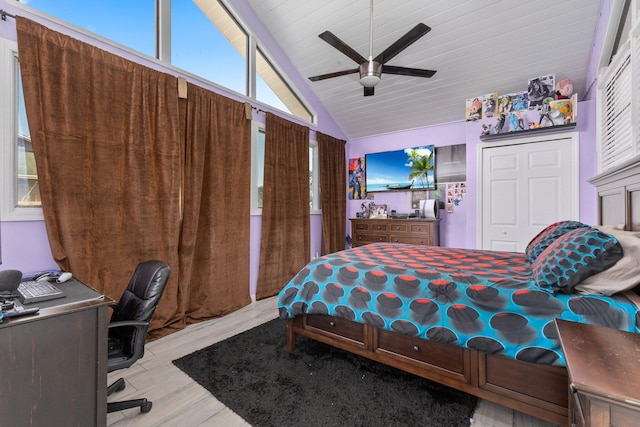 bedroom with lofted ceiling, ceiling fan, wood finished floors, wood ceiling, and a closet