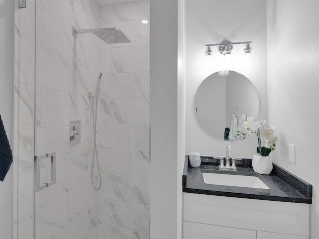 bathroom featuring vanity and an enclosed shower