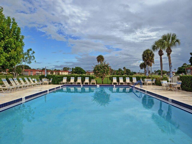 view of swimming pool with a patio area