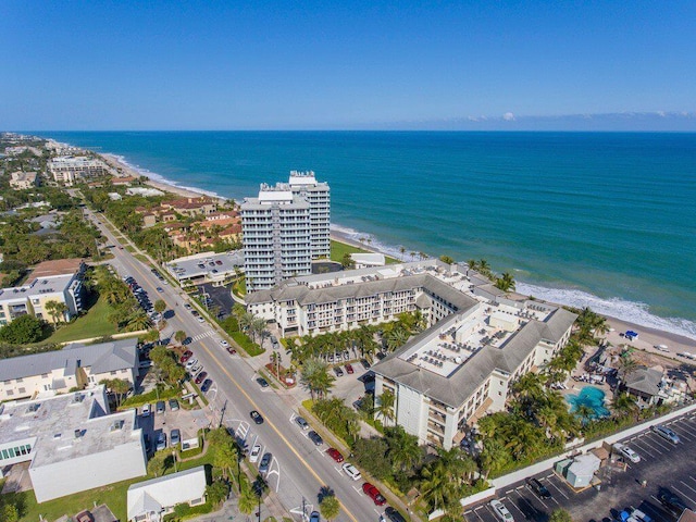 bird's eye view featuring a water view and a view of the beach