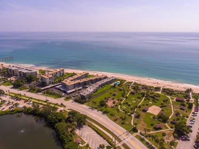 birds eye view of property with a water view and a view of the beach