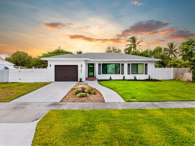 view of front of home featuring a yard and a garage