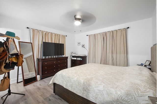 bedroom with ceiling fan and light wood-type flooring