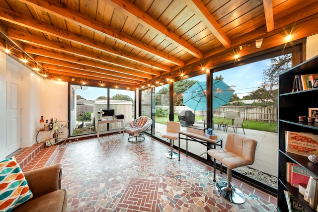 sunroom featuring beam ceiling and wooden ceiling