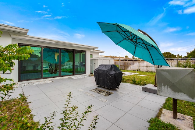 view of patio / terrace featuring a grill and a storage shed