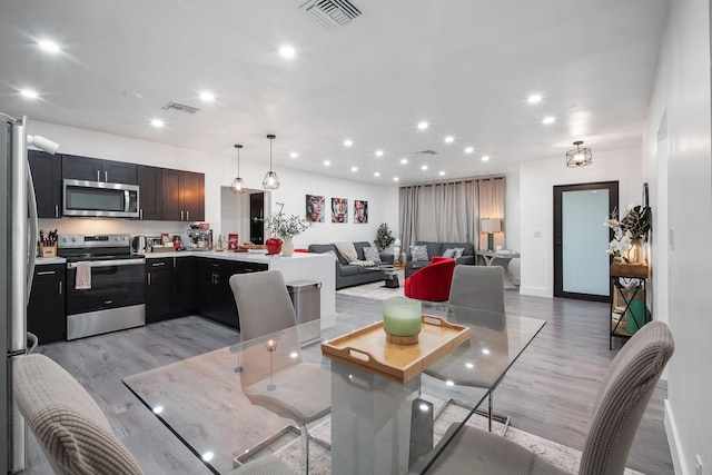 dining space featuring light hardwood / wood-style flooring