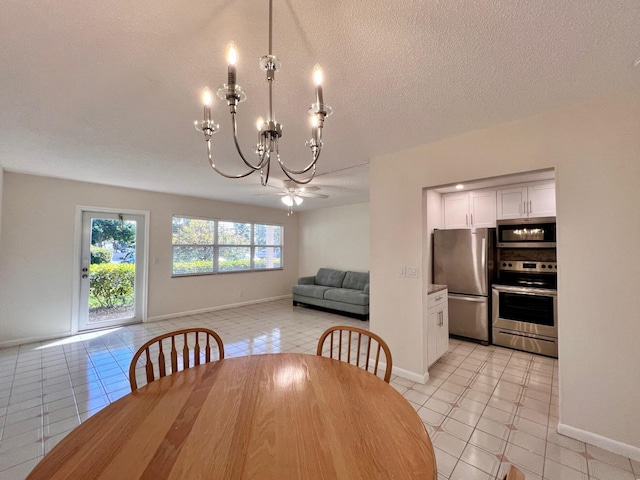 unfurnished dining area with light tile patterned floors, ceiling fan with notable chandelier, and a textured ceiling