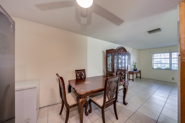 tiled dining room with ceiling fan