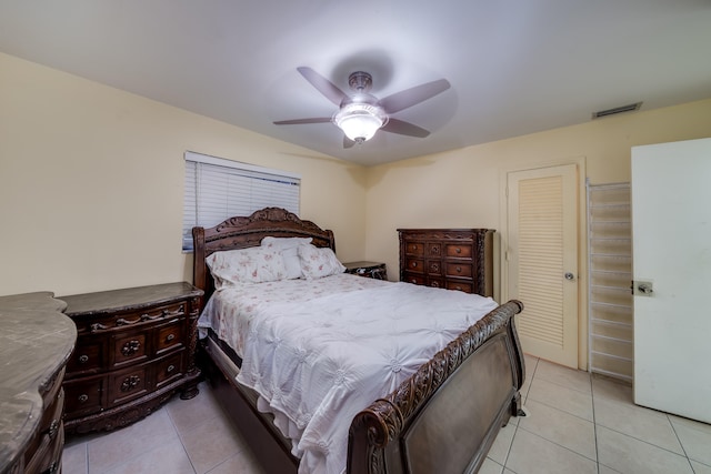 bedroom featuring ceiling fan, a closet, and light tile patterned flooring