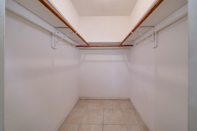 spacious closet with light tile patterned floors