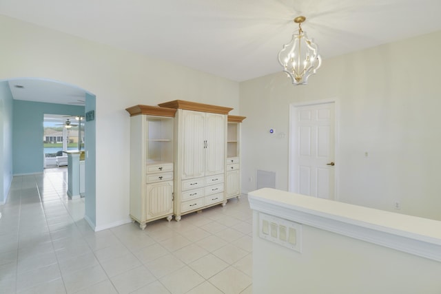 interior space featuring light tile patterned floors and an inviting chandelier