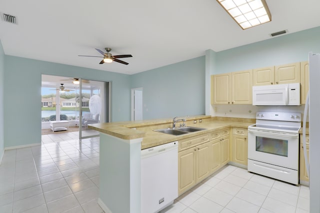 kitchen featuring sink, white appliances, kitchen peninsula, and light tile patterned floors