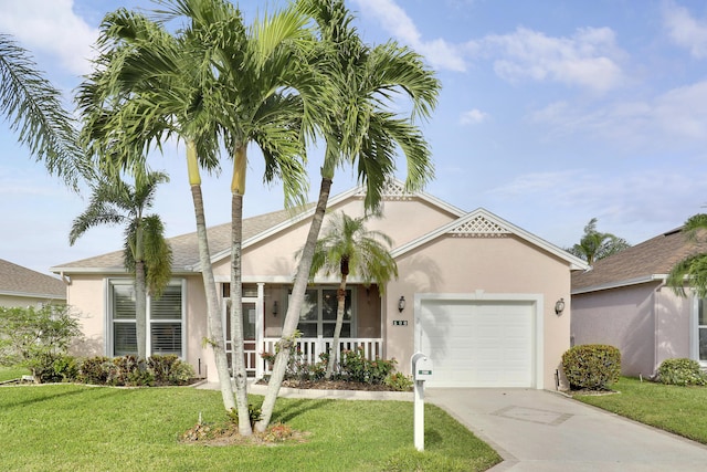 view of front of house featuring a porch, a garage, and a front lawn