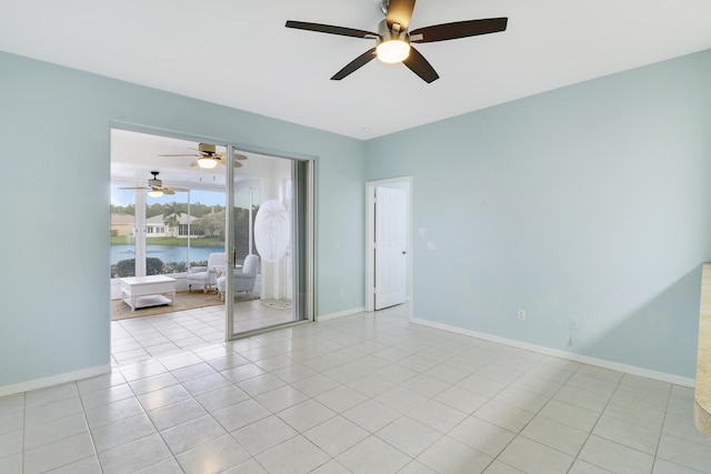 empty room with light tile patterned flooring and a water view